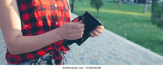 Woman Holding Empty Wallet In The Street