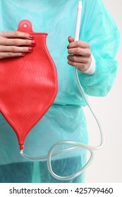 Woman Holding An Enema Bag 