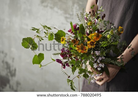 Similar – Female hands holding flower vase with wild flowers