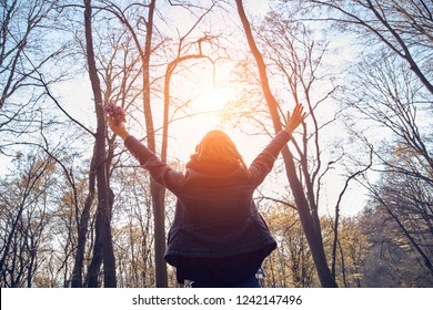 Woman Holding Flowers With Arms Wide Open.