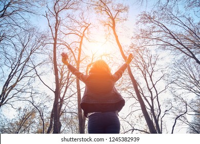 Woman Holding Flowers With Arms Wide Open.