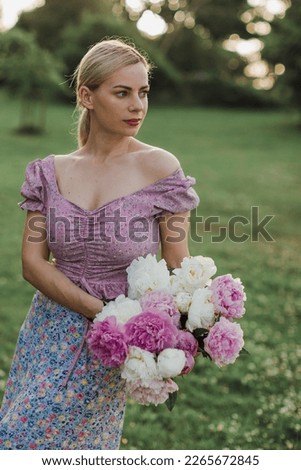 Woman holding flowers peonies bouquet