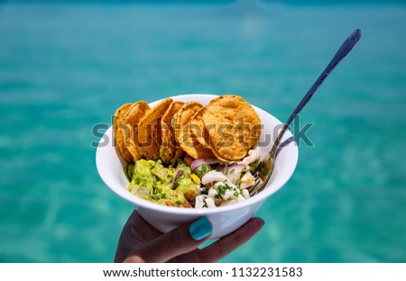 Woman Holding Fresh Ceviche Guacamole and Tortilla Chips Snack Bowl Made in Tropical Paradise