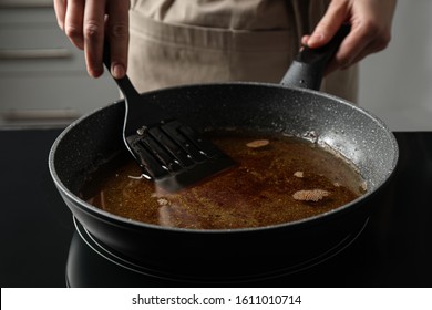 Woman Holding Frying Pan With Used Cooking Oil, Closeup