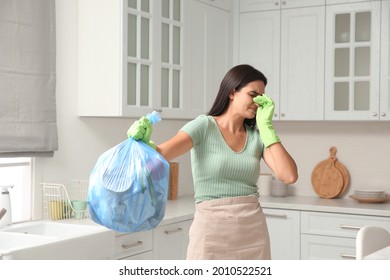 Woman Holding Full Garbage Bag At Home