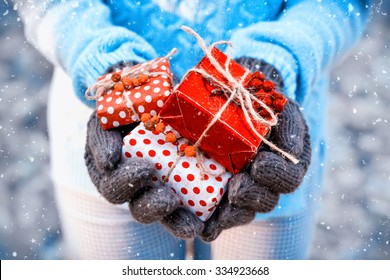 Woman Holding A Gift Box In A Gesture Of Giving. Christmas Holiday Concept,vintage Filter,soft Focus.