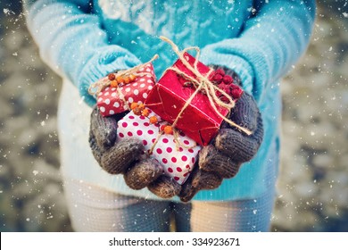 Woman Holding A Gift Box In A Gesture Of Giving. Christmas Holiday Concept,vintage Filter,soft Focus.