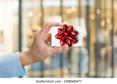 Woman Holding Gift Card In A Restaurant Or Shop