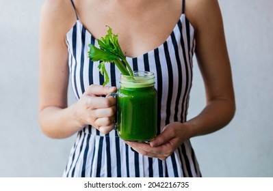 Woman Holding A Glass With Celery Juice