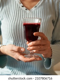 Woman Holding A Glass Of Freshly Squeezed Red Beet Juice