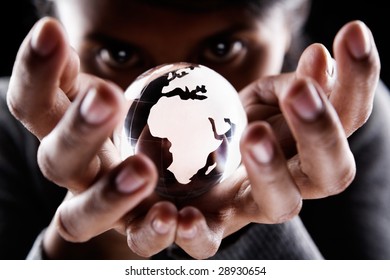 A Woman Holding A Glass Globe With Mysterious Looking, Showing Africa And Europe Continent