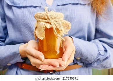 Woman Holding Glass Jar Of Honey