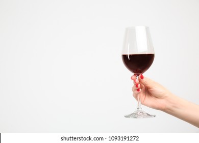 Woman Holding Glass Of Red Wine On White Background