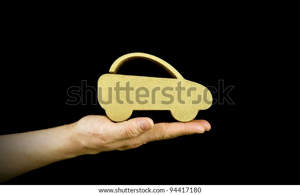 woman holding a
gold car with black
background
