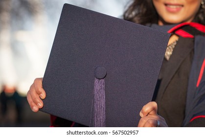 Woman Holding Graduation Cap