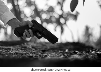 Woman Holding A Gun In Hand. - Violence And Crime Concept.