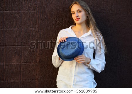 Woman holding in hand hat