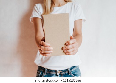 Woman Holding In Hand Small Paper Box. Young Girl With New Package. Postal Service, Delivery. Craft Paper. Gift Box, Present. Box Closeup. Blank Packing, Empty Space. People Communication. Carton Case