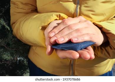 Woman Holding Hand Warmer Outdoors, Closeup View