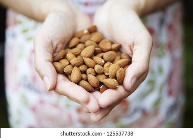 Woman Holding Handful Of Almonds