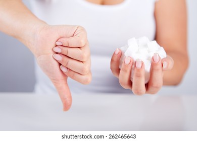 Woman Is Holding A Handful Of Sugar Cubes