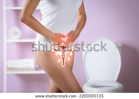Woman holding hands on her belly and illustration of female reproductive system. Vaginal yeast infection