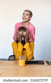 Woman Holding Hands Over The Eyes Of Surprised Black Woman. Lesbian Couple Moving In Together.