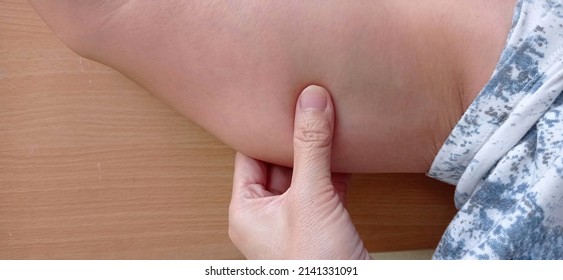 Woman Holding Hands Under Her Forearm.