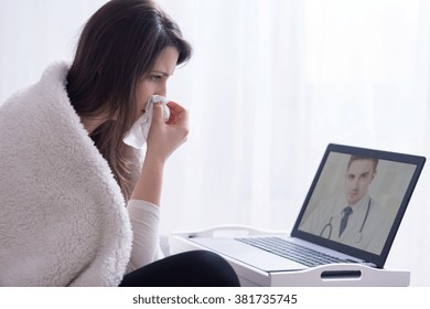 Woman Holding Hanky During Consultation With Skype Doctor