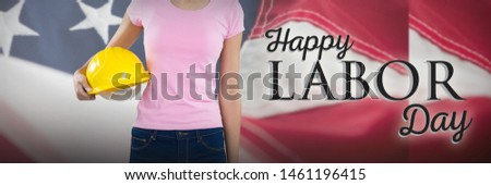 Woman holding hard hat against grey background against full frame of american flag. USA Labor Day Concept Advertisement. USA Labor Day Concept Advertisement