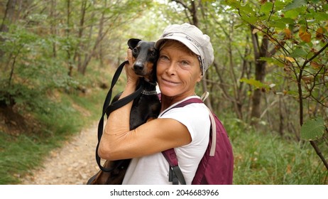 Woman Holding Her Cute Dachshund, Middle-aged Woman Enjoying Life