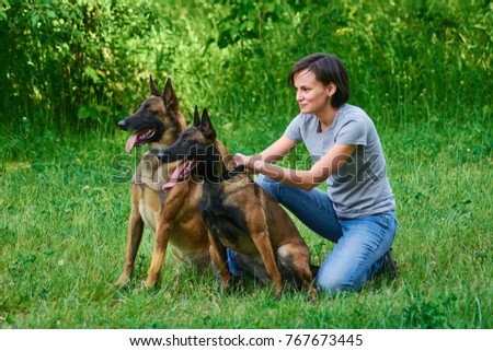 Similar – Pretty blond woman with her two dogs