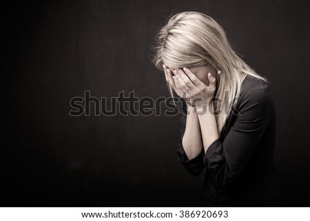 Woman holding her face in her hands 