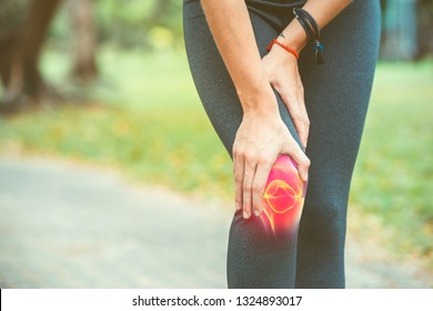 Woman holding her knee with red pain on the skeleton