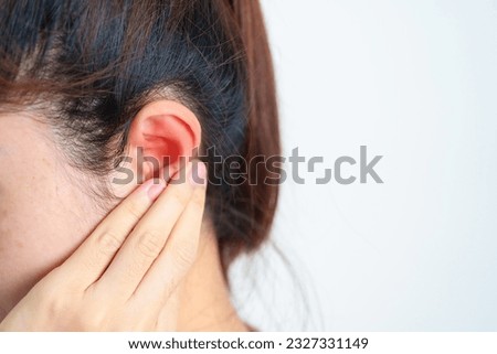 Woman holding her painful Ear. Ear disease, Atresia, Otitis Media, Inflation, Pertorated Eardrum, Meniere syndrome, otolaryngologist, Ageing Hearing Loss and Health concept