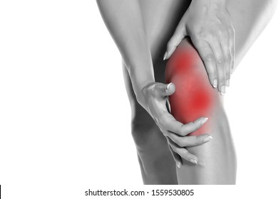 woman holding her painful knee on white background