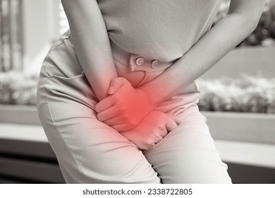 woman holding her pee, health care concept of urinary tract infection; urinary incontinence; overactive bladder symptoms