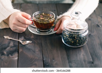 Woman Holding Hot Cup Of Black Tea With Herbs