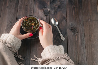 Woman Holding Hot Cup Of Black Tea With Herbs