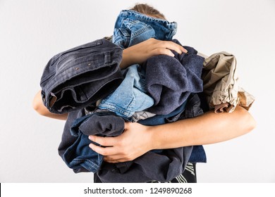 Woman Holding Huge Pile Of Clothes - Laundry Concept