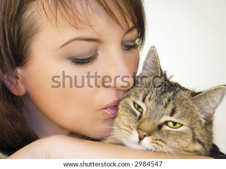 woman holding, hugging, kissing her little cat