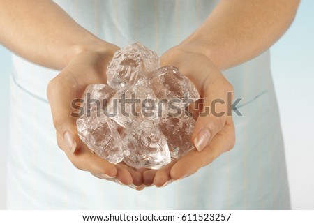 WOMAN HOLDING ICE CUBES