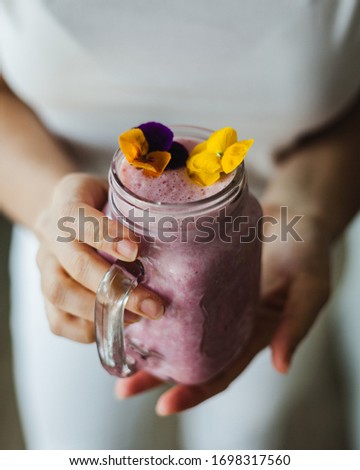 Similar – Mann hält einen Milchshake aus Beeren und Haferflocken.