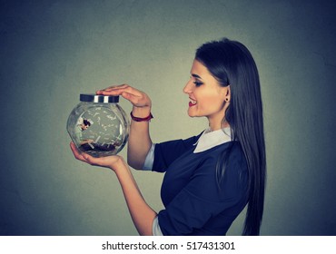 Woman Holding A Jar With Imprisoned Man In It Working On Laptop Under Money Rain 