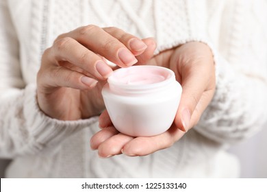 Woman Holding Jar Of Moisturizing Cream, Closeup. Winter Skin Care Cosmetic