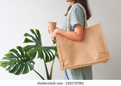 Woman holding  jute bag or sack bag on white background. Reusable shopping bag. Natural material. Zero waste. Plastic free. Eco friendly concept. - Powered by Shutterstock