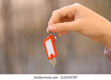 Woman Holding Key On Chain Outdoors