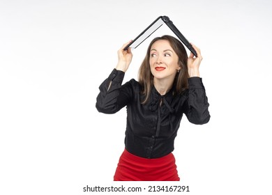 Woman is holding laptop above her. Businesswoman on white. Human hides behind laptop as roof. Woman is trying to hide under laptop. Concept of protection using portable computer.