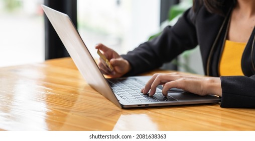 A Woman Holding A Laptop COMPUTER   And Credit Card For Shopping Online And Payment.Blank Screen Monitor For Graphic Display Montage