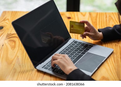 A Woman Holding A Laptop COMPUTER   And Credit Card For Shopping Online And Payment.Blank Screen Monitor For Graphic Display Montage